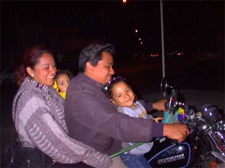 Jeune famille se promenant en moto le samedi soir